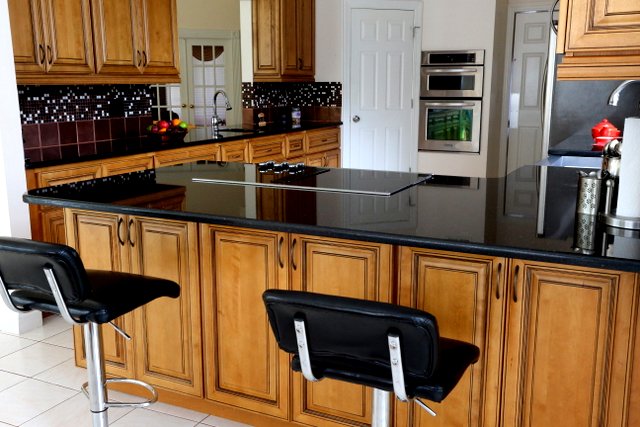 Kitchen With Black Counters Cabinets