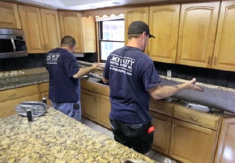 Experienced stone installers complete the granite installation