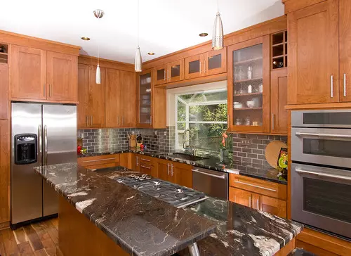 grey granite countertops with brown cabinets