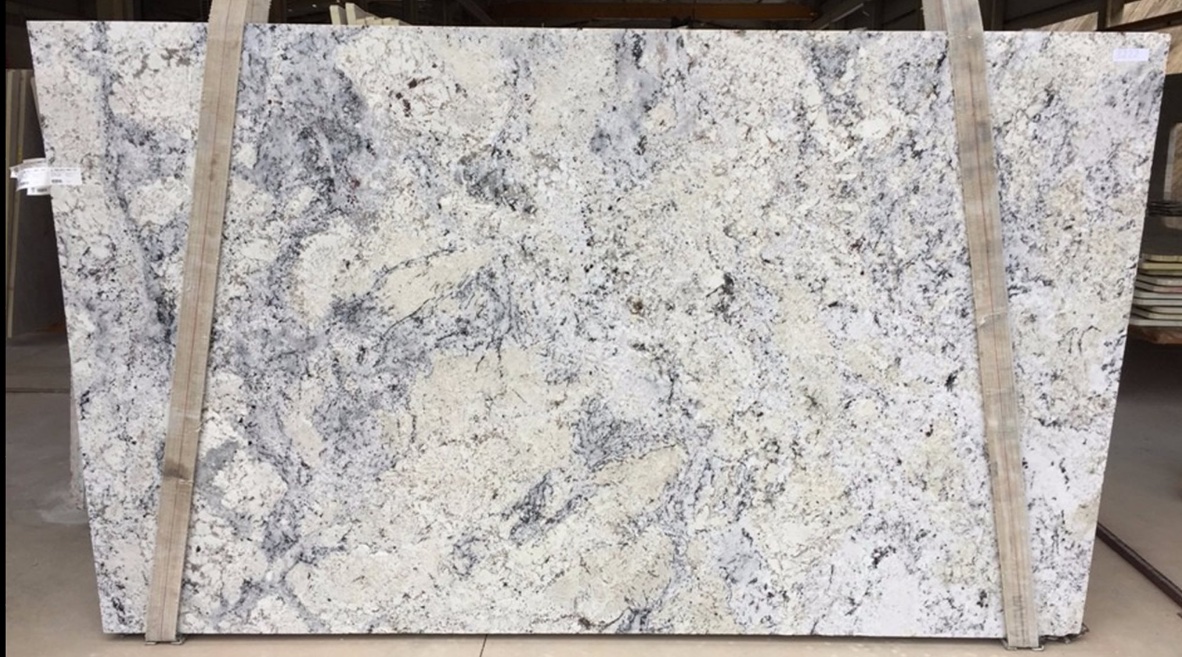 White Ice - a white and creamy background stone with rich blue gray aders