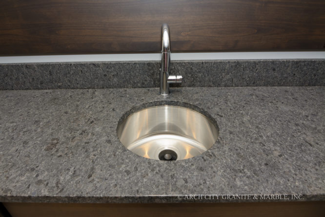 Close up of Steel Grey brushed granite with 4” backsplash and Stainless steel bar sink in st louis home