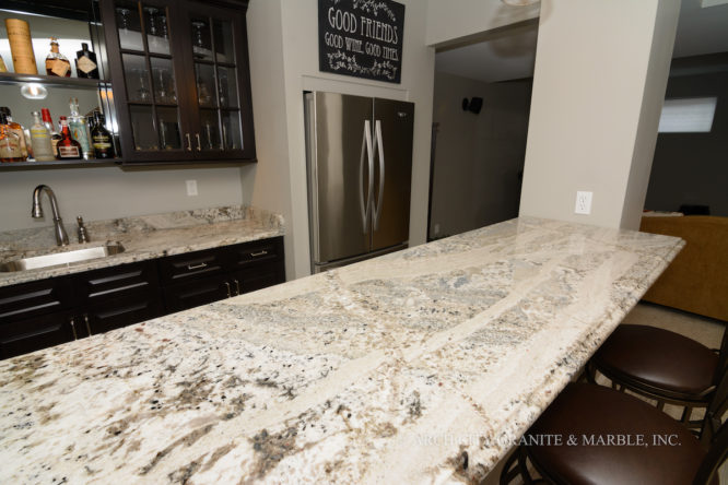 Monte Cristo granite countertops for a beautiful basement bar with Espresso cabinets in Collinsville, IL