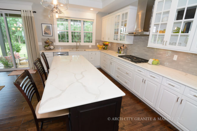 Quartz countertops that look like marble installed in a kitchen with white and black cabinets in st louis area