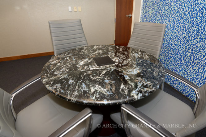 Round conference table of Mari Blue granite accommodating four office chairs in missouri area