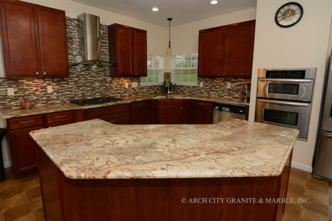 Typhoon Bordeaux granite island for a butterfly shaped kitchen island installed without seams in Missouri