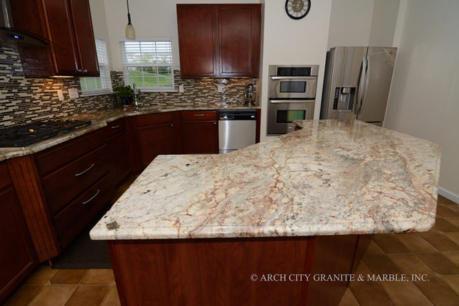 Typhoon Bordeaux granite island with a decorative edge in webster grove