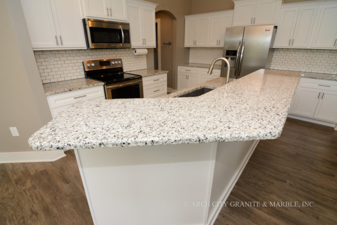 Luna Pearl granite, white cabinets, white tile backsplash creating a clean white kitchen