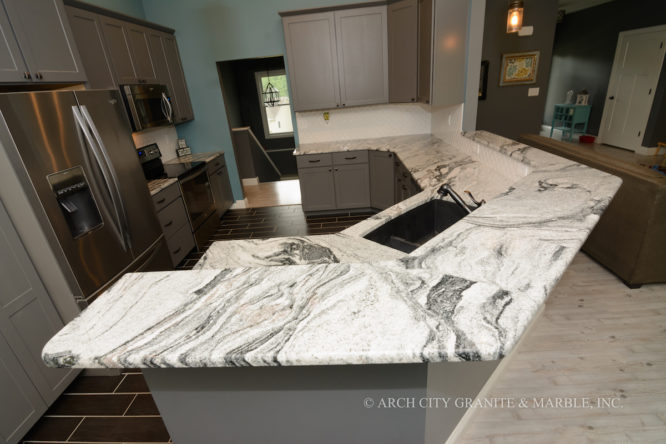 Silver Cloud granite, Grey cabinets, White backsplash creating a stunningly beautiful kitchen in a Union, MO home