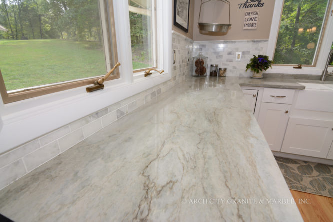 Sea Pearl quartzite with White cabinets and matching subway tile backsplash in missouri