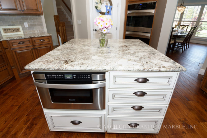 White glazed cabinetry in missouri matched with white granite with a hint of brown
