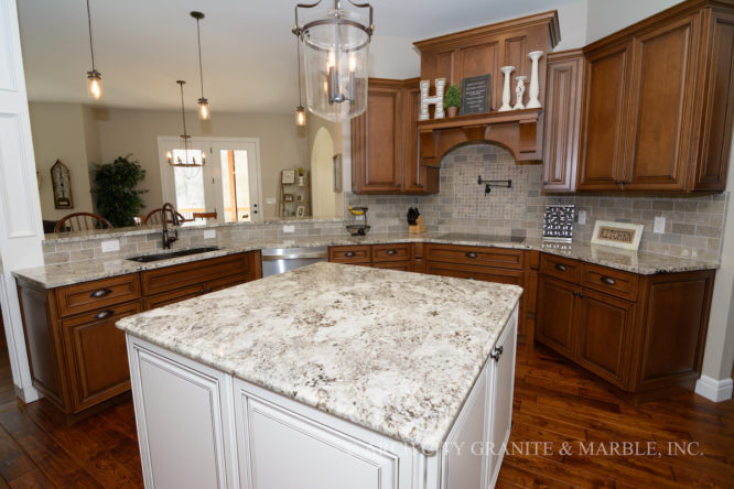 Alaska White granite kitchen island with white cabinets in a Wentzville, MO home